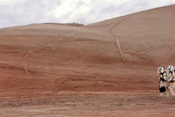 In this April 19, 2004, file photo, crew commander Gus Frederick and Greg Drayer, left, explore the terrain outside the Mars Desert Research Station northwest of Hanksville, Utah. Researchers at Brigham Young University are helping with a NASA-sponsored project measuring the electrical charge and size of dust particles on Mars.