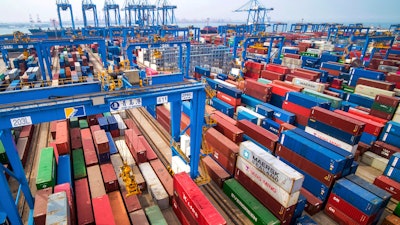 In this Tuesday, May 14, 2019, photo, containers are piled up at a port in Qingdao in east China's Shandong province. China's imports from the United States plunged 31.4% in June from a year earlier amid a tariff war with Washington, while exports to the U.S. market sank 7.8%, Customs data showed Friday, July 12, 2019.