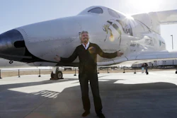In this Sept. 25, 2013, file photo, British entrepreneur Richard Branson poses with the SpaceShipTwo at a Virgin Galactic hangar at Mojave Air and Space Port in Mojave, Calif.