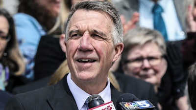 In this April 11, 2018, file photo, Vermont Gov. Phil Scott speaks before signing a bill on the steps of the Statehouse in Montpelier, Vt.