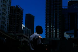 In this June 12, 2019, file photo a man walks in downtown Miami. Ten straight years of growth. Unemployment at a five-decade low. Higher wages for the poorest workers. The economic expansion that just became America’s longest on record didn’t produce an especially fast pace of growth. It didn’t narrow the vast gap between the wealthiest Americans and everyone else.