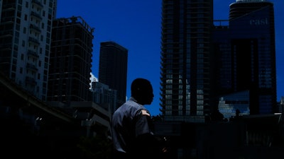 In this June 12, 2019, file photo a man walks in downtown Miami. Ten straight years of growth. Unemployment at a five-decade low. Higher wages for the poorest workers. The economic expansion that just became America’s longest on record didn’t produce an especially fast pace of growth. It didn’t narrow the vast gap between the wealthiest Americans and everyone else.