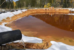 In this Oct. 12, 2018, file photo, water contaminated with arsenic, lead and zinc flows from a pipe out of the Lee Mountain mine and into a holding pond near Rimini, Mont. An appeals court Friday, July 19, 2019, has sided with the Trump administration after it dropped a proposal that would have required mining companies to prove they have the wherewithal to clean up future pollution.