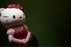 In this Thursday, Oct. 30, 2014 file photo, a model dressing as Japanese character Hello Kitty waits for guests to pose for a souvenir photo at Sanrio Puroland, a theme park featuring Hello Kitty in Tokyo. European Union antitrust authorities have fined the Japanese company behind Hello Kitty for restricting cross-border sales of toys, mugs, bags and other products featuring the cartoon cat girl. The EU’s antitrust commissioner, Margrethe Vestager, said Sanrio was fined 6.2 million euros ($7 million) because the company violated the bloc’s competition rules.