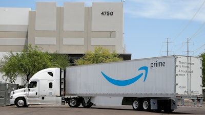 This Wednesday, July 17, 2019 photo shows an Amazon shipping truck at a fulfillment center in Phoenix. Amazon.com Inc. reports financial earnings on Thursday, July 25.