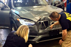 In this March 20, 2018, file photo, provided by the National Transportation Safety Board, investigators examine a driverless Uber SUV that fatally struck a woman in Tempe, Ariz. Police outside Phoenix recently closed part of a street to conduct a lighting test as an investigation continues into the 2018 death of a woman who was struck and killed by an Uber self-driving SUV. The Maricopa County Attorney’s Office says prosecutors asked for more investigation before making a decision about whether to charge backup driver Rafaela Vasquez who was supposed to take control in an emergency. Another prosecutor’s office decided in March not to charge Uber.