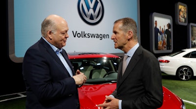 In this Jan. 14, 2019, file photo Ford Motor Co. President and CEO, Jim Hackett, left, meets with Dr. Herbert Diess, CEO of Volkswagen AG, at the North American International Auto Show in Detroit. Ford and Volkswagen are planning to unveil details about their budding alliance to build mobility services and autonomous and electric vehicles. Executives from both companies are planning to reveal details Friday, July 12.