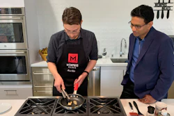 In this photo taken April 11, 2019, Memphis Meats CEO Uma Valeti, right, watches chicken produced in a laboratory from chicken cells being cooked in Emeryville, Calif. The company is focused on reducing the cost of cultured meat and producing larger quantities. A plate of chicken that used to cost tens of thousands of dollars to produce can now be made for less than $100, Valeti said.