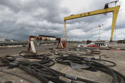 Cables strewn over the ground in front of the Samson Crane at the Harland and Wolff shipyard after workers voted to continue their occupation of the shipyard, Belfast, Northern Ireland, Monday, Aug. 5, 2019.