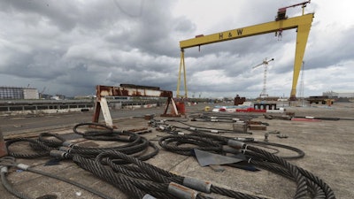 Cables strewn over the ground in front of the Samson Crane at the Harland and Wolff shipyard after workers voted to continue their occupation of the shipyard, Belfast, Northern Ireland, Monday, Aug. 5, 2019.