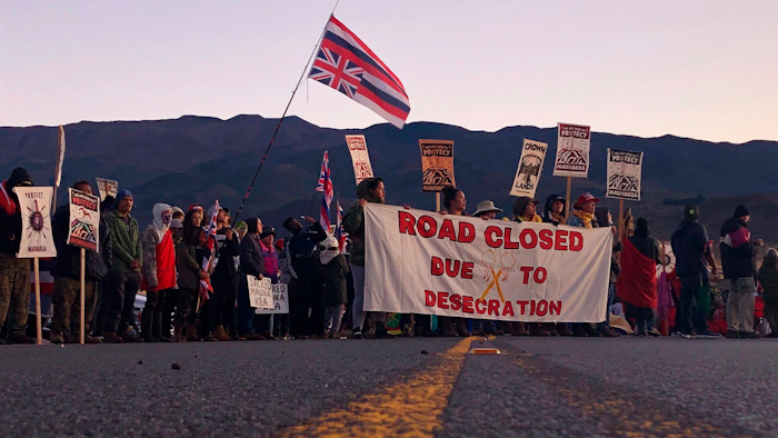 In this July 15, 2019, file photo, demonstrators block a road in Mauna Kea, Hawaii, to protest the construction of a giant telescope.