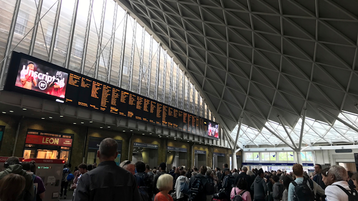 People wait for trains at King's Cross station in London, Saturday, Aug. 10, 2019.