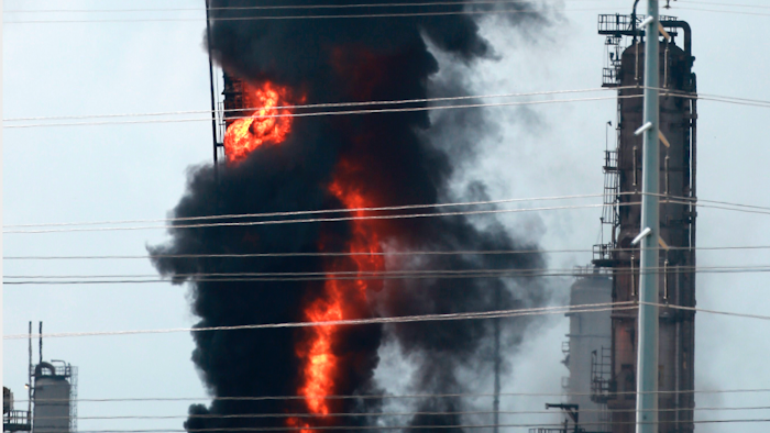 Flames and smoke rise after a fire started at an Exxon Mobil facility, Wednesday, July 31, 2019, in Baytown, Texas.
