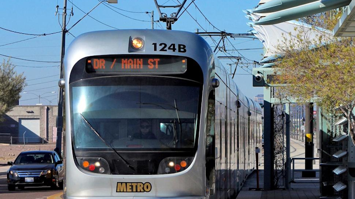In this Jan. 16, 2016, file photo, a Metro Light Rail train stops for passengers in Phoenix.