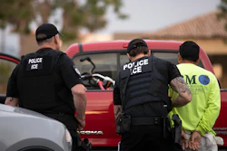 In this July 8, 2019, file photo, U.S. Immigration and Customs Enforcement officers detain a man during an operation in Escondido, Calif.
