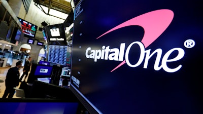 In this Tuesday, July 30, 2019, file photo, the logo for Capital One Financial appears above a trading post on the floor of the New York Stock Exchange.