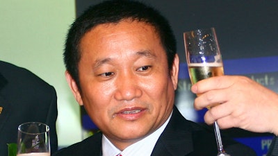 In this May 8, 2009, file photo, Liu Zhongtian, chairman of China Zhongwang Holdings Limited, celebrates at the company's listing ceremony in the Hong Kong Stock Exchange.