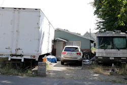 Vehicles are parked outside the home of Paige A. Thompson, who uses the online handle 'erratic,' Wednesday, July 31, 2019, in Seattle. Thompson was taken into custody Monday at her home and has been charged with computer fraud and abuse in connection with hacking data from more than 100 million Capital One credit holders or applicants.