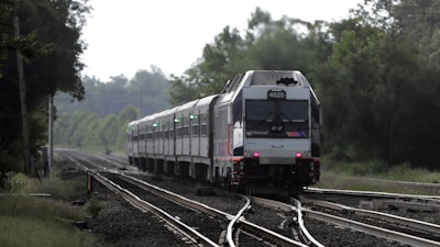 This Aug. 3, 2018, file photo shows a New Jersey Transit train leaving the Bound Brook Station in Bound Brook, N.J.