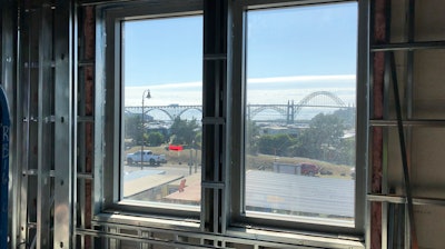 In this July 22, 2019, photo, the Yaquina Bay Bridge seen through the window of Oregon State University's Marine Studies Building, which is being erected in a tsunami inundation zone in Newport, Ore.