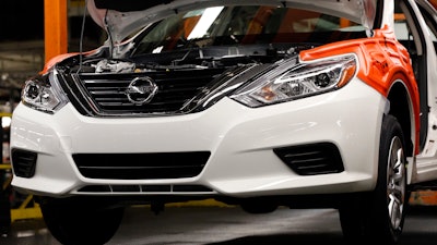 In this April 6, 2016, file photo, a new 2016 Altima awaits additional engine work on the assembly line at the Nissan Canton Vehicle Assembly Plant in Canton, Miss.