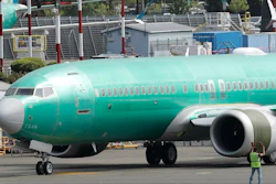 In this May 8, 2019, file photo, a worker stands near a Boeing 737 Max 8 jetliner prior to a test flight in Renton, Wash.