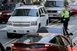 In this April 21, 2017, file photo, a San Francisco Municipal Transit Agency officer directs traffic in San Francisco.