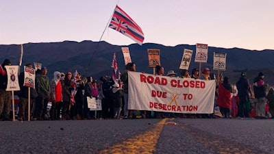 In this July 15, 2019, file photo, demonstrators block a road in Mauna Kea, Hawaii, to protest the construction of a giant telescope.