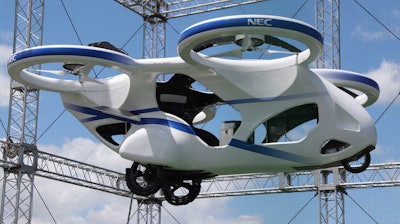 NEC Corp.'s machine with propellers hovers at the company's facility in Abiko near Tokyo, Monday, Aug. 5, 2019. The Japanese electronics maker showed a 'flying car,' a large drone-like machine with four propellers that hovered steadily for about a minute.
