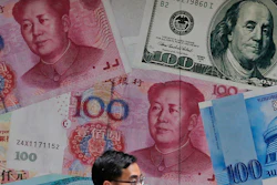 In this June 10, 2019, file photo, a man walks past a money exchange shop decorated with different banknotes at Central, a business district of Hong Kong.