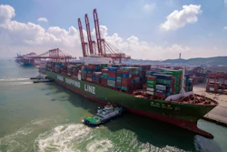 In this Aug. 6, 2019, photo, tugboats manuever a container ship at a port in Qingdao in eastern China's Shandong province.