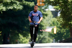 A man rides an electric scooter Thursday, Aug. 8, 2019, in Atlanta.