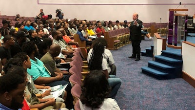 In this Aug. 6, 2019, photo, Mayor Mike Duggan speaks with Detroit residents during a job readiness event where they pre-registered to apply for jobs at a coming Fiat Chrysler assembly plant.