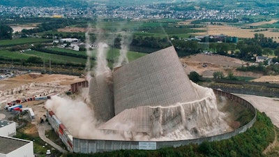 The Muelheim-Kaerlich plant collapses after remote-controlled excavators removed pillars that supported the tower, near Koblenz, Germany, Friday, Aug. 9, 2019.