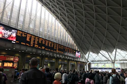 People wait for trains at King's Cross station in London, Saturday, Aug. 10, 2019.