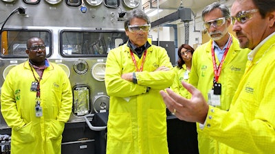 In this May 10, 2017, file photo, U.S. Secretary of Energy Rick Perry, second from left, at the Los Alamos Laboratory Plutonium Facility in Los Alamos, N.M.