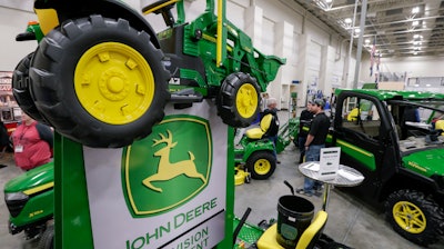 In this Feb. 23, 2018, file photo, John Deere products on display at a home and garden trade show in Council Bluffs, Iowa.