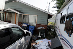 In this July 31, 2019, file photo, vehicles are parked outside the home of Paige A. Thompson, who uses the online handle 'erratic,' in Seattle.