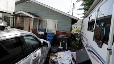 In this July 31, 2019, file photo, vehicles are parked outside the home of Paige A. Thompson, who uses the online handle 'erratic,' in Seattle.