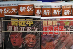 In this July 4, 2019, photo, Chinese magazines with front covers featuring Chinese President Xi Jinping and U.S. President Donald Trump on trade war are placed for sale at a roadside bookstand in Hong Kong.