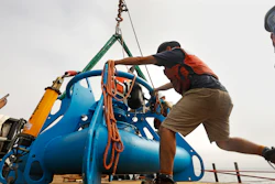In this Aug. 8, 2019 photo, Jeff Pietro, a senior engineer assistant for Woods Hole Oceanographic Institute in Massachusetts, helps move the anchoring system for a microphone as it is into the Santa Barbara Channel.