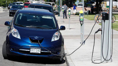 In this June 26, 2018, file photo, a Nissan Leaf at a recharge station in downtown Denver.