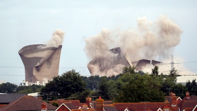 The cooling towers at the disused coal-fired Didcot power station in Oxfordshire, England, are demolished Sunday Aug. 18, 2019.