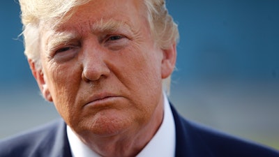 In this Aug. 18, 2019, photo, President Donald Trump speaks with reporters before boarding Air Force One at Morristown Municipal Airport in Morristown, N.J.