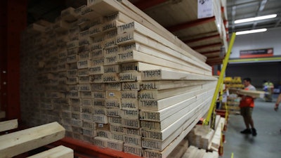 In this July 11, 2019, file photo, lumber is stacked at the Home Depot store in Londonderry, N.H.