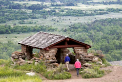 In this June 11, 2014, file photo, visitors hike to a stone lookout over the Little Missouri River inside the Theodore Roosevelt National Park, North Dakota.