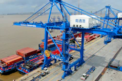 In this July 18, 2019, file photo, shipping containers are loaded onto a cargo ship at a port in Nantong, China.
