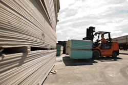 In this May 22, 2009, file photo, Michael Hilton uses a forklift to move sheets of Chinese-made drywall onto a flat bed truck at Venture Supply Inc. in Norfolk, Va.