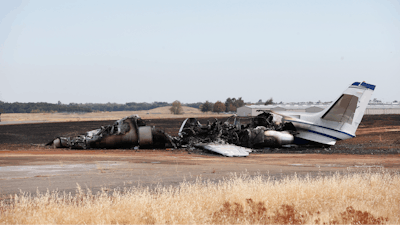 The burned out remains of a twin-engine Cessna Citation sits at the end of a runway after the pilot aborted the takeoff at the Oroville Airport in Oroville, Calif., Wednesday, Aug. 21, 2019. The plane carried two pilots and eight passengers, who all escaped injury. Firefighters were able to quickly control a grass fire that broke out and temporarily closed Highway 162. No cause of the crash has been listed.