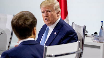 French President Emmanuel Macron, left, and President Donald Trump, right, participate in a G-7 Working Session in Biarritz, France, Sunday, Aug. 25, 2019.